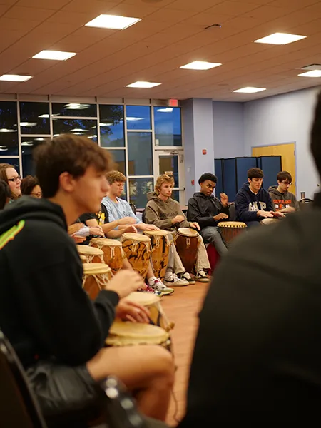 International students playing drums during diversity week at Thomas College