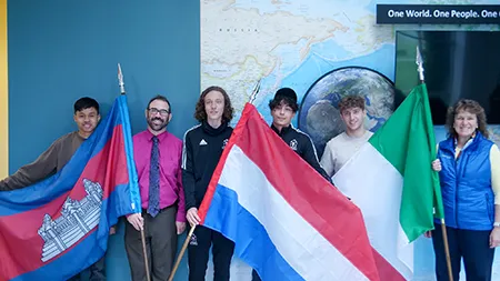 Laurie Lachance and international students during flag installation ceremony