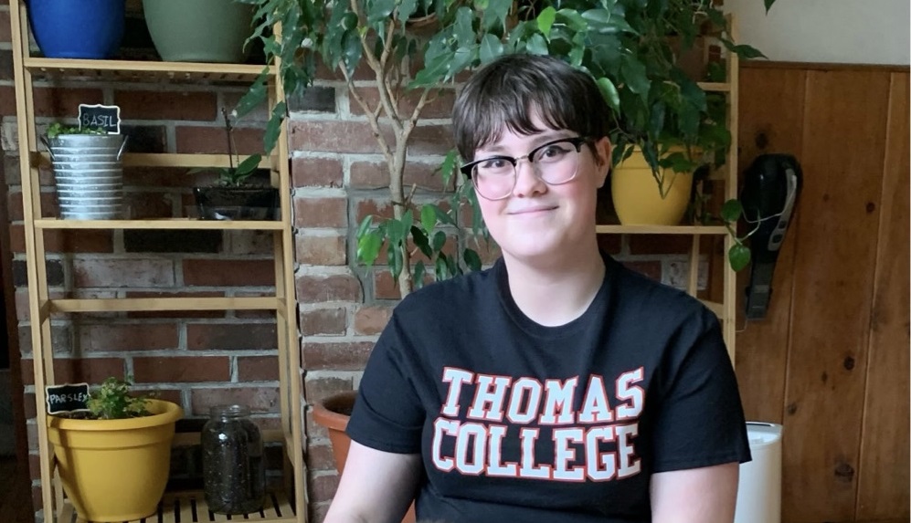 person sitting and smiling at camera