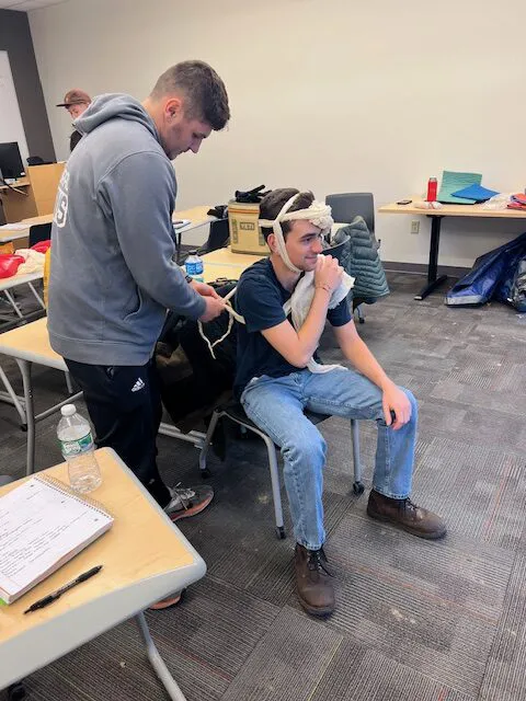 Students being trained in outdoor first aid learned and practiced skills to deal with a myriad of injuries associated with the outdoors including soft tissue wounds, broken limbs, skin burns, shock, head injuries, hypothermia, heart attacks, and diabetic events.