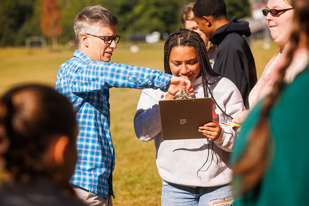 Tess Harden teaches students in the field at Thomas College