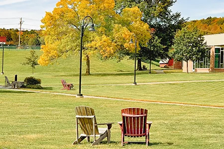 Two lawn chairs on Thomas College Quad. See our programs list view.