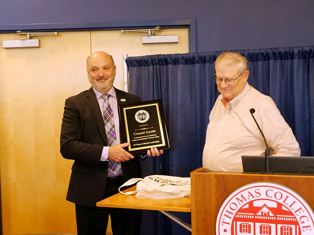 Thomas College Trustee Conrad Ayotte receiving an award