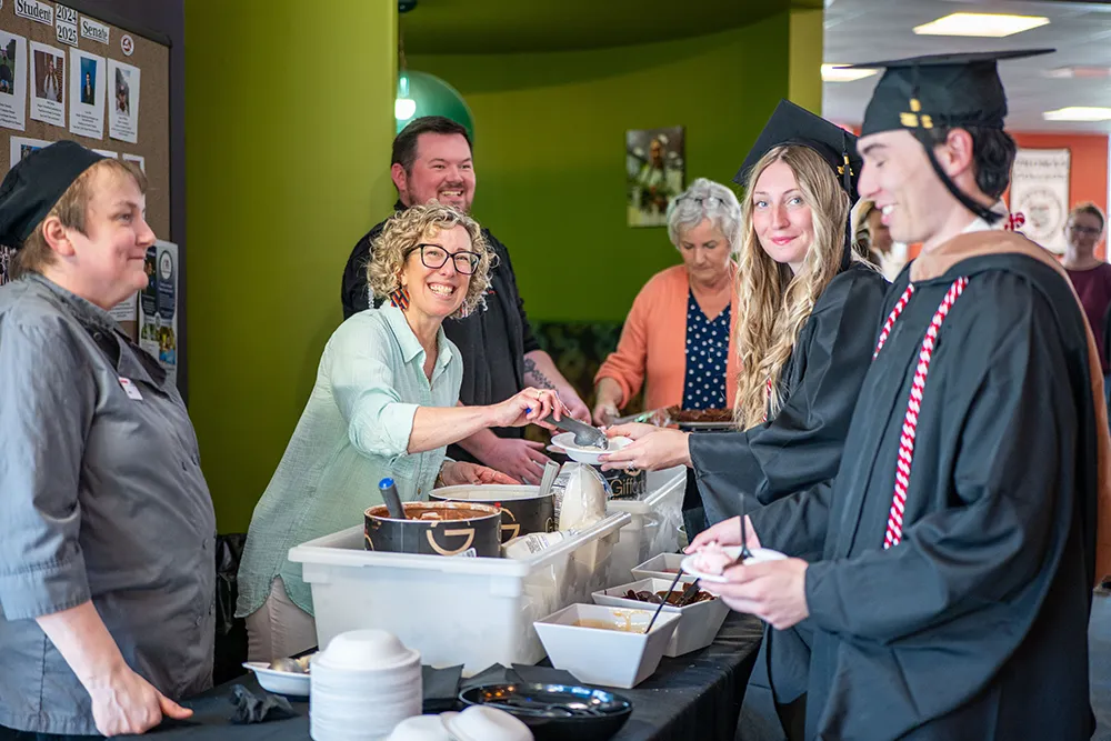 Dr. Jeannine Diddle Uzzi serving up ice cream to our college graduates