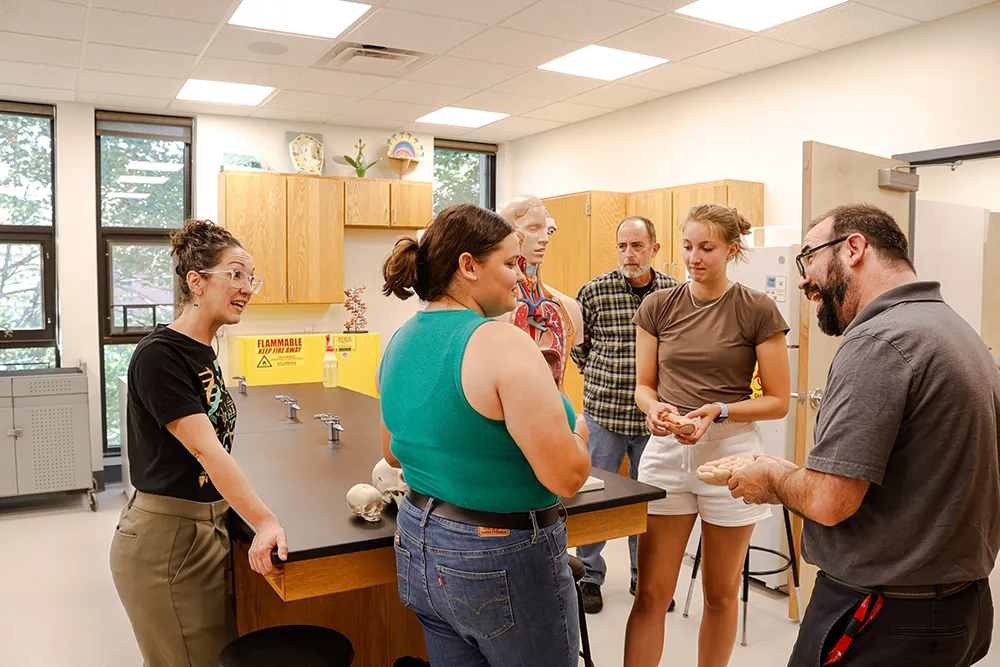 Allison Moloney and Luke Shorty in the lab with students