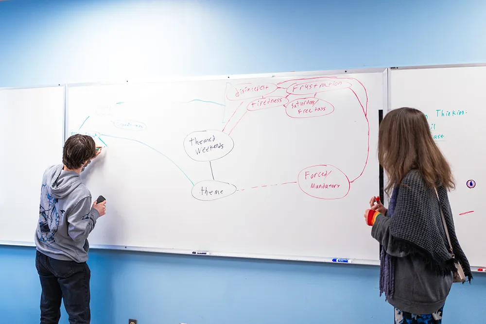 Maine School of Science and Mathematics (MSSM) Students working at a whiteboard