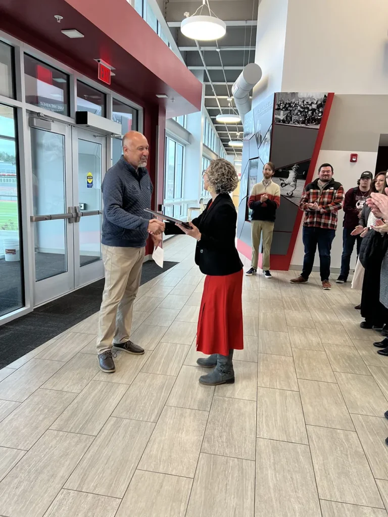 President Uzzi accepting award from Sheridan Construction's Dan Wildes