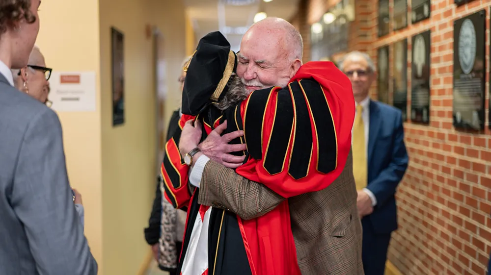 President Uzzi gets a huge hug from a colleague on Inauguration Day