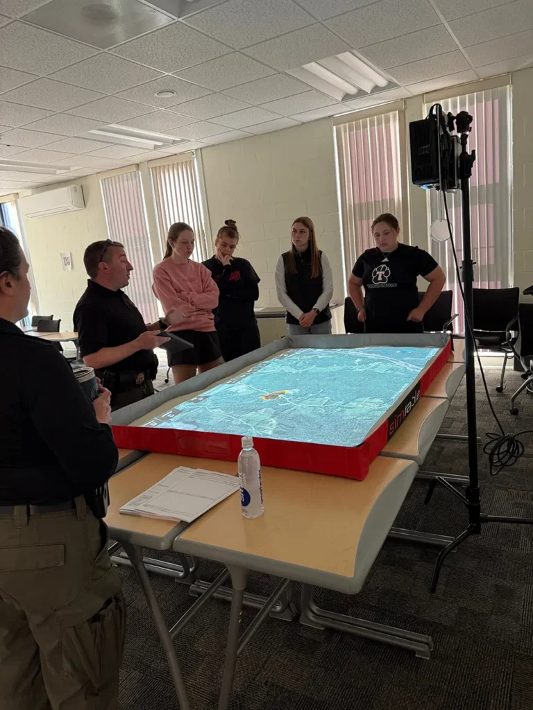 Students analyzing a simulated map of Waterville, Maine on a light table