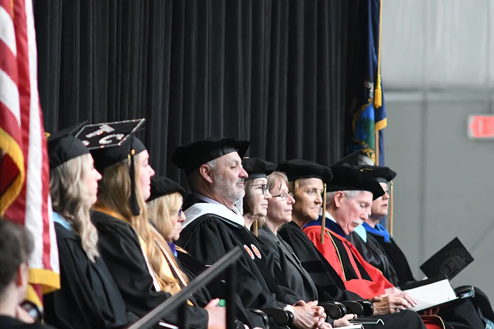 Conrad Ayotte on the commencement stage with others