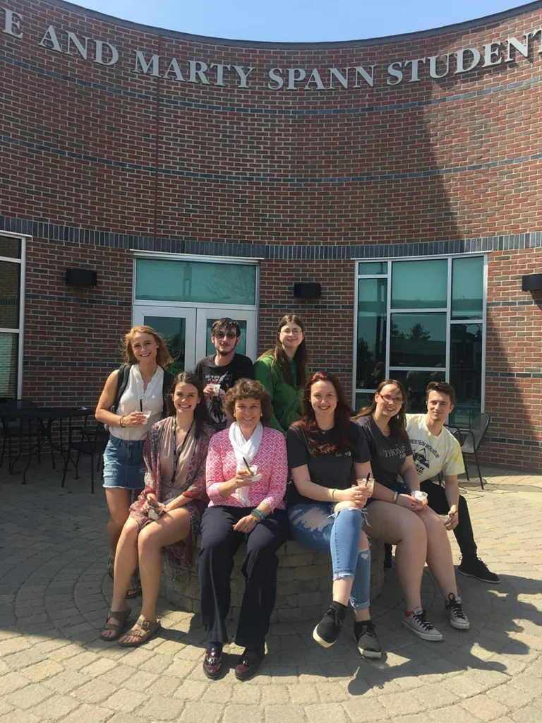 Laurie Lachance with students outside the Spann Commons eating ice cream
