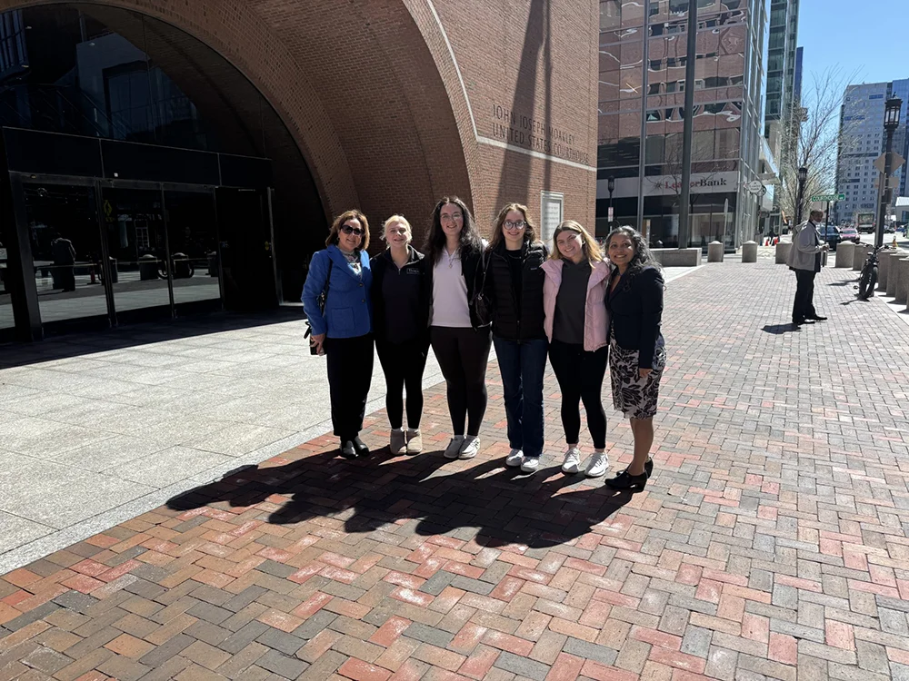 thomas college science professor alicia mccarthy with students outside of court house