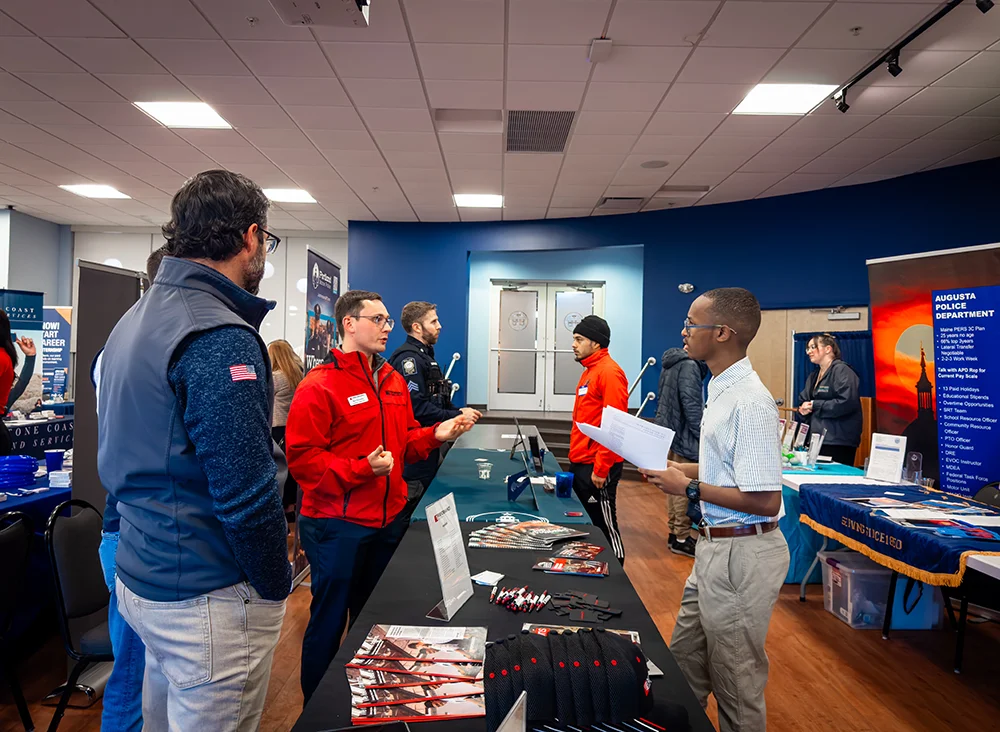 A Thomas College student discusses job and internship opportunities with an employer during the Thomas College Career Fair in October
