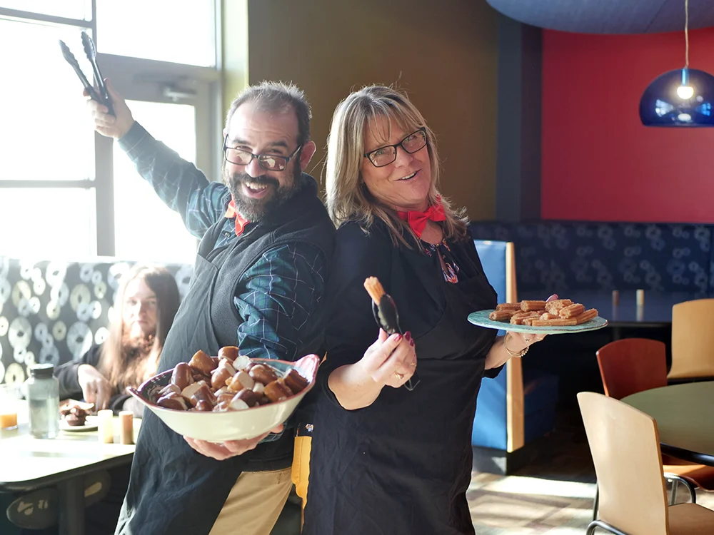 Thomas College staff member Jan Landry is always willing to lend a hand, like during Student Appreciation Day giving out favorite foods to students with Luke Shorty