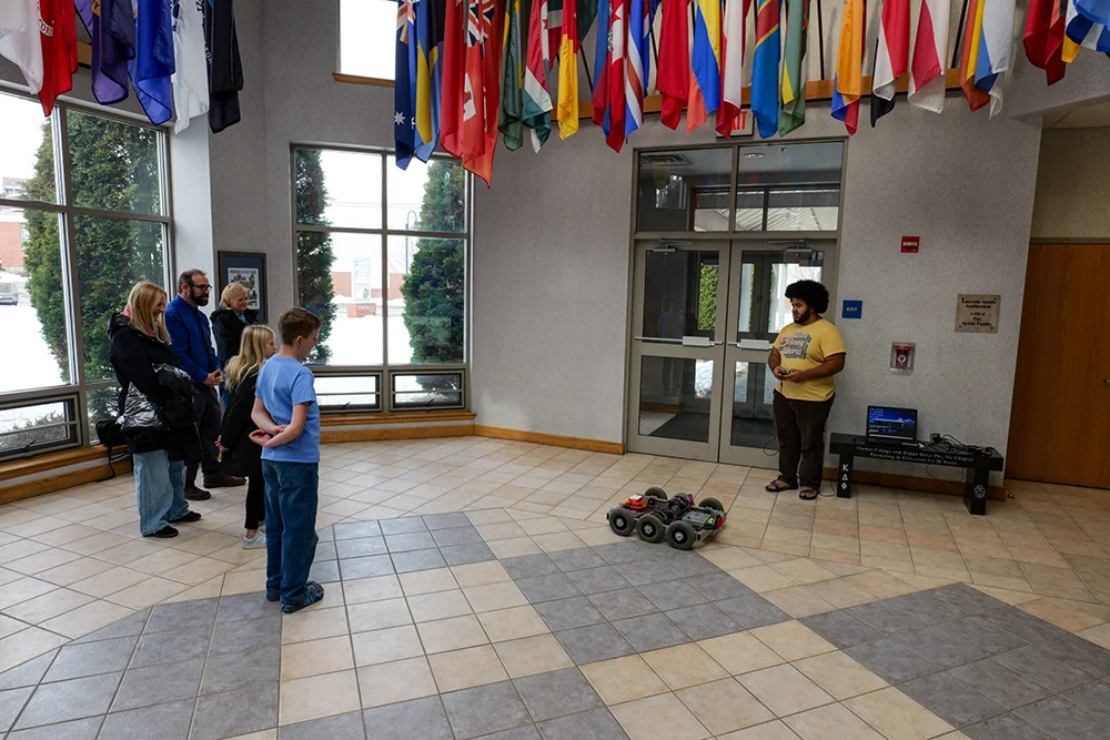 Thomas College Hosts First NASA-Supported Robotics Event for Maine Students: Students in the Hall of Flags with Robot