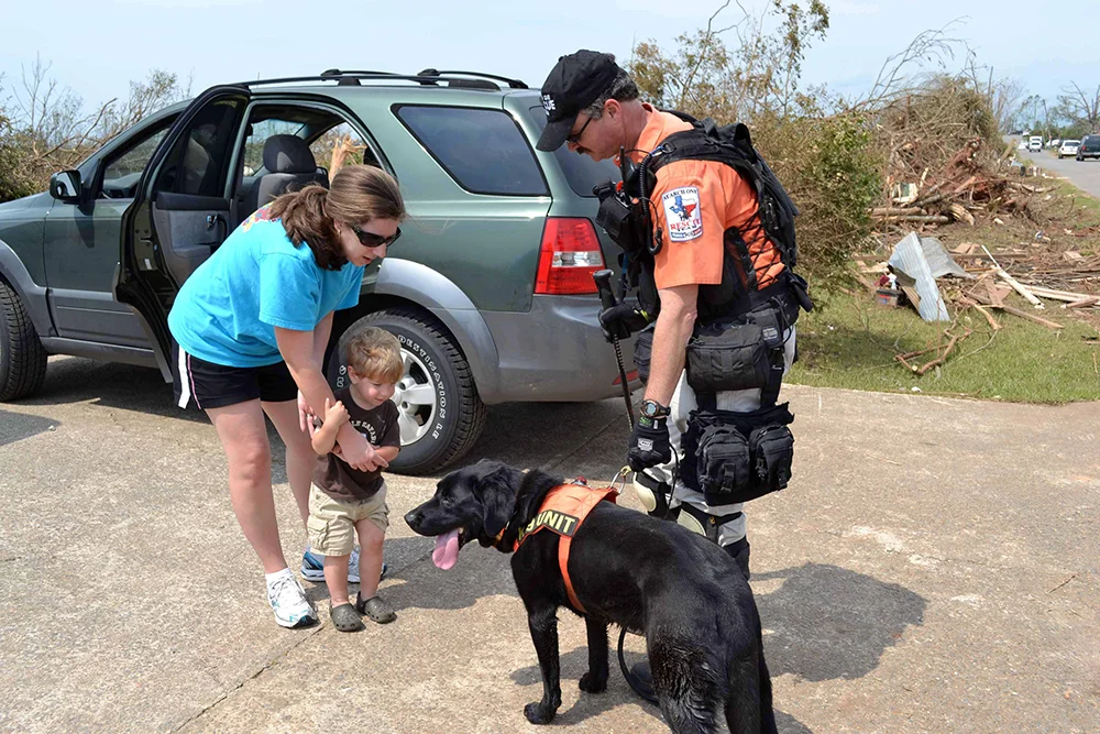 Search and Rescue K9 Shadow and Handler meet with disaster victims