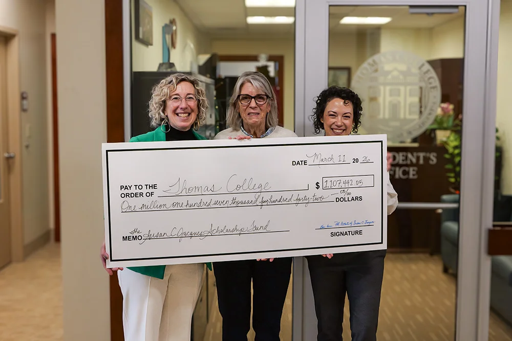 Susan C. Jacques leaves $1.2 million gift to College, presenting the check to Thomas is her cousin, Laurah Brown