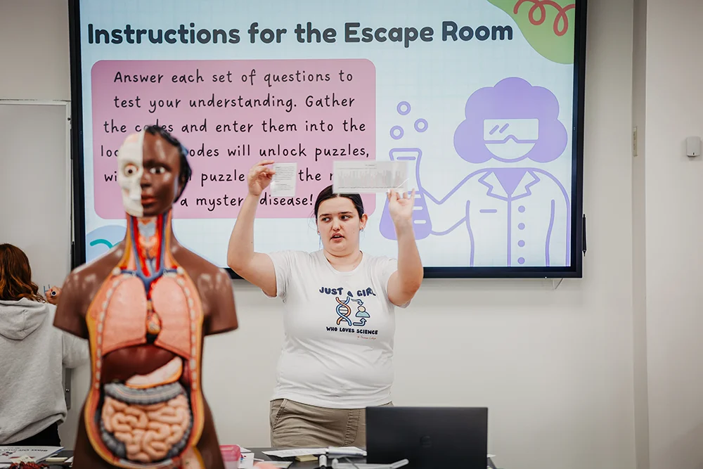 Thomas student Katy McIntyre teaches a class during Girls in Science Day at Thomas College in the science lab