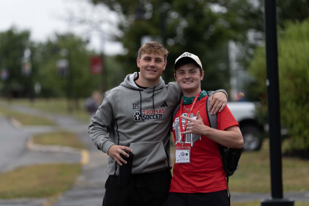 two students posing together outside on campus during move in day 2026