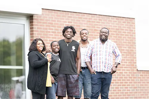 Entering student posing with his family during move-in weekend 2026