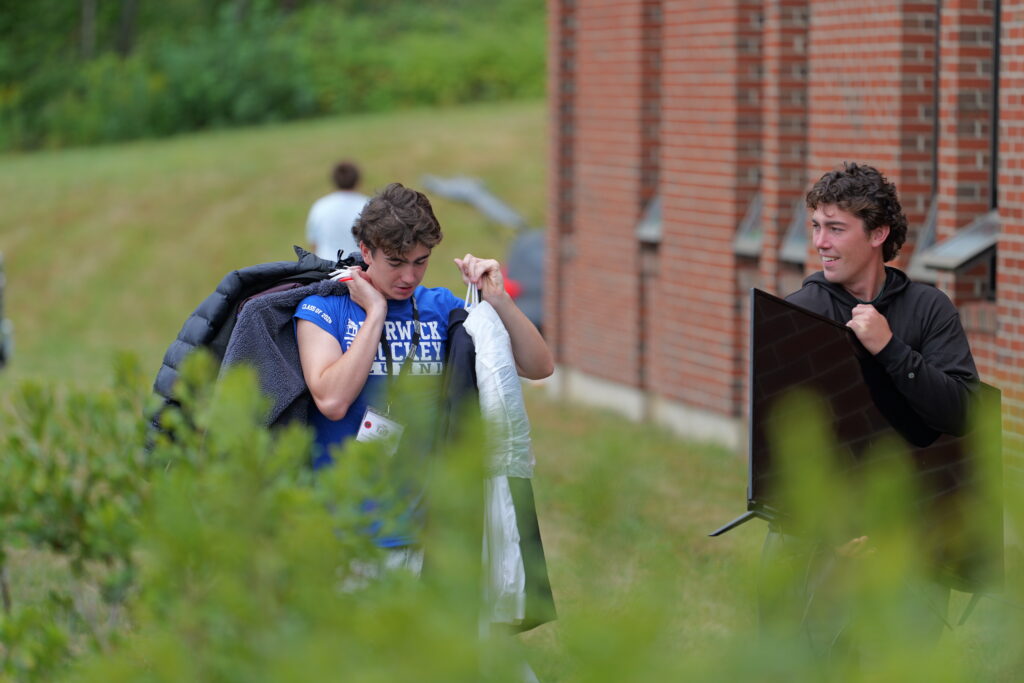 An entering holding items to move into a residence hall