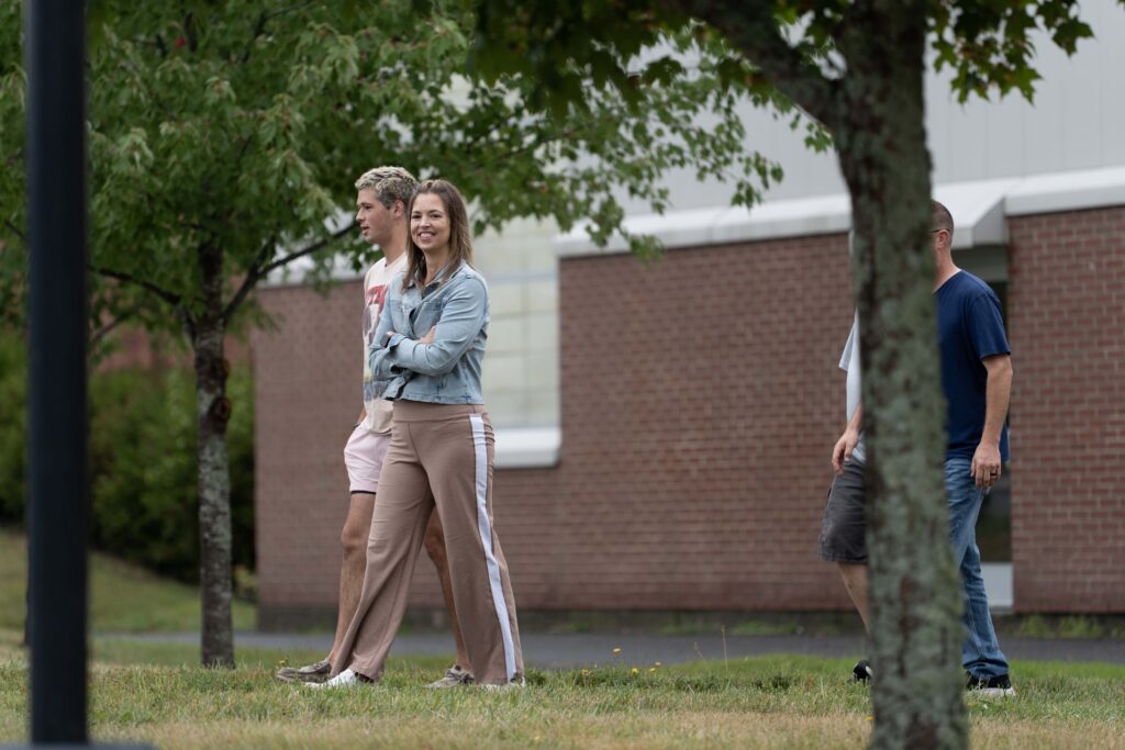 a family and student walking during move in and orientation