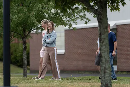 a family and student walking during move in and orientation