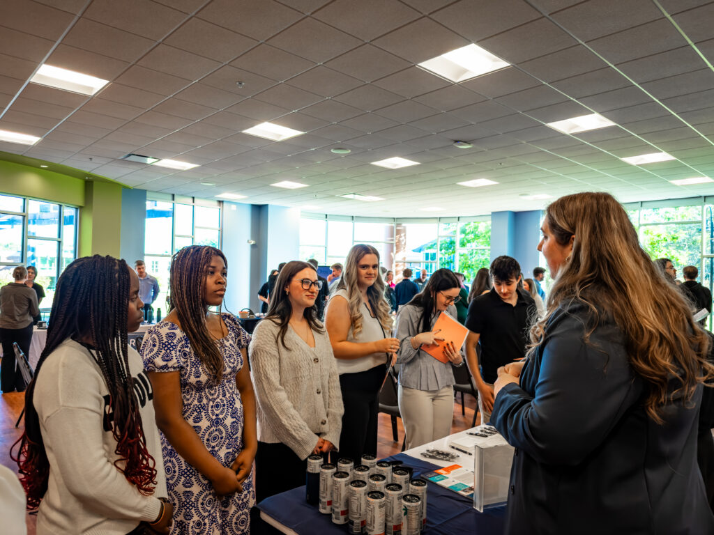 Thomas College students chatting with an accounting firm staff member during accounting firm night at Thomas College