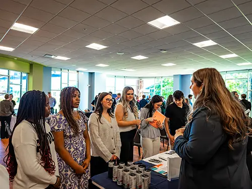 Thomas College students chatting with an accounting firm staff member during accounting firm night at Thomas College