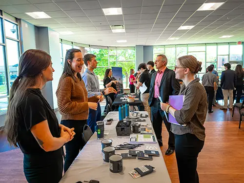 Thomas College students chatting with an accounting firm staff member during accounting firm night at Thomas College
